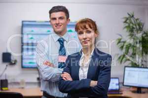 Smiling technicians standing at the camera with arms folded