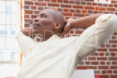 Casual businessman looking up and thinking