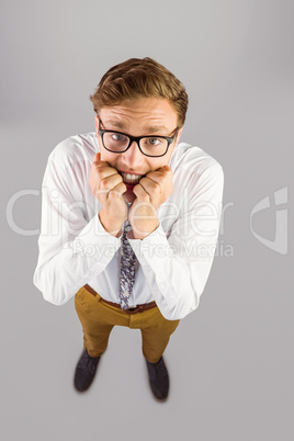 Young geeky businessman biting his nails