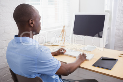 Casual businessman looking at computer screen