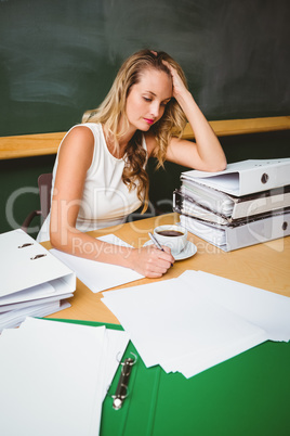 Beautiful businesswoman writing document at desk