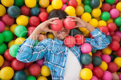 Cute boy smiling in ball pool