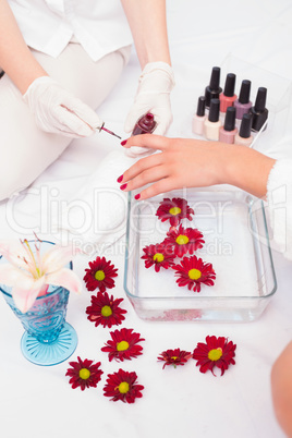 Woman getting her nails painted