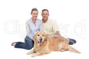 Portrait of smiling couple sitting together with their dog