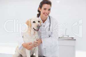 Happy veterinarian examining a cute dog