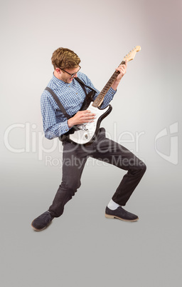 Geeky hipster playing the guitar