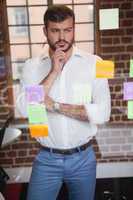 Casual businessman looking at sticky notes