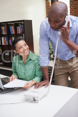 Casual business team working together at desk