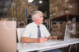 Warehouse manager using laptop