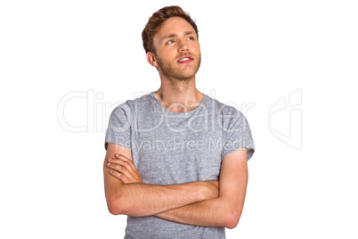 Thoughtful young man with arms crossed