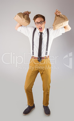 Geeky businessman holding paper bags