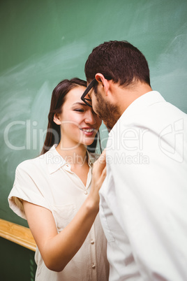 Businessman and woman looking at each other in office