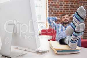 Casual businessman with his feet up on desk