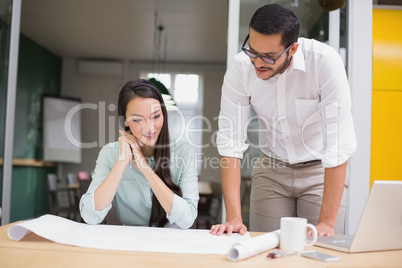 Casual architecture team working together at desk