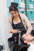 Hair stylist washing mans hair