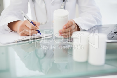 Doctor writing out prescriptions