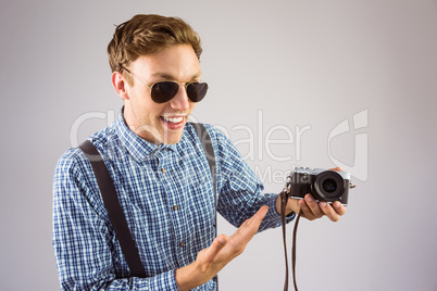 Geeky hipster holding a retro camera