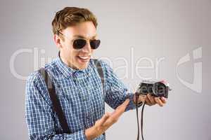 Geeky hipster holding a retro camera