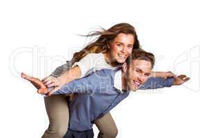 Smiling young man carrying woman