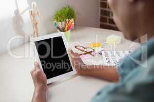 Casual businessman using tablet pc