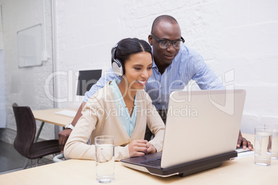 Business team working happily together on laptop