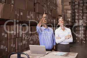 Colleague with laptop at warehouse