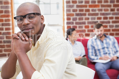 Hipster businessman looking at camera