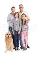 Portrait of smiling family standing together with their dog