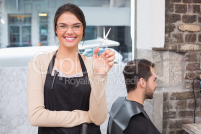 Pretty hair stylist smiling at camera