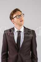 Young businessman thinking and looking up