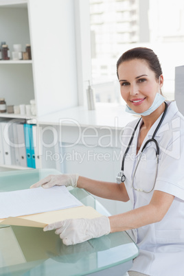 Smiling doctor holding a medical file