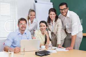 Casual business team having a meeting using laptop