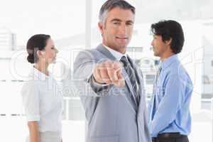 Businessman pointing to the camera