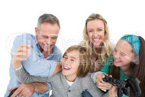 Happy family with two children playing video games