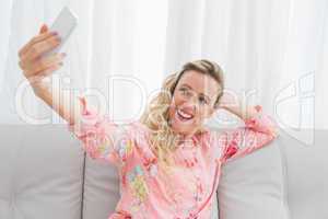 Pretty woman taking a picture of herself with mobile phone