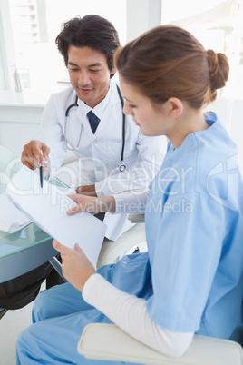 Doctor and surgeon reviewing notes