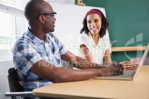 Partners working at desk using laptop