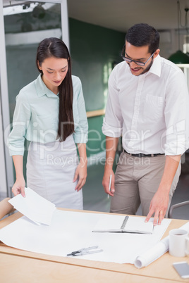 Casual architecture team working together at desk