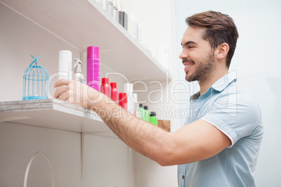 Smiling hairdresser with hair products