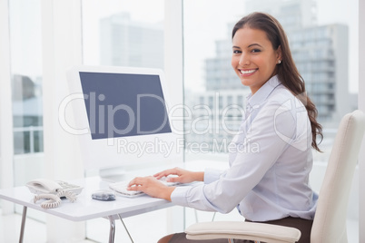 Smiling businesswoman working at her desk