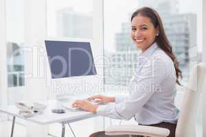 Smiling businesswoman working at her desk