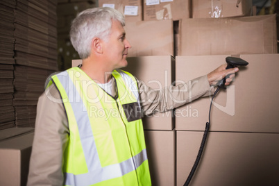 Worker scanning package in warehouse