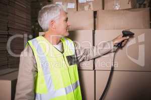 Worker scanning package in warehouse