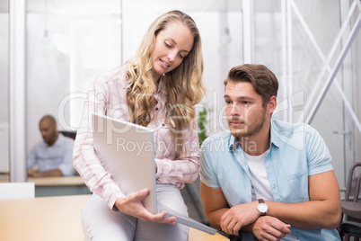 Businesswoman showing something on the computer