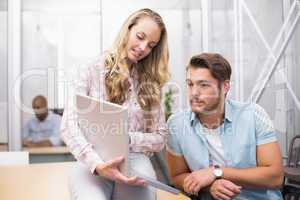 Businesswoman showing something on the computer