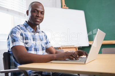 Cheerful creative businessman working on computer