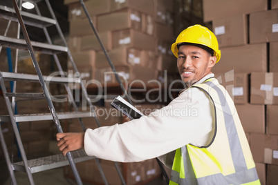 Worker with diary in warehouse