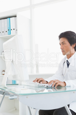 Serious doctor using the computer