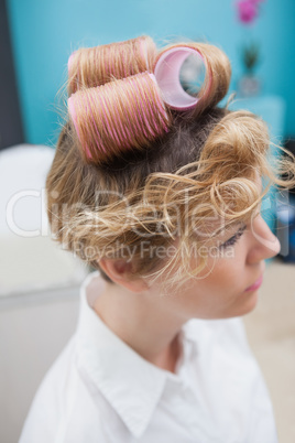 Customer sitting with curlers in hair