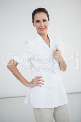 Smiling doctor with hand on hip